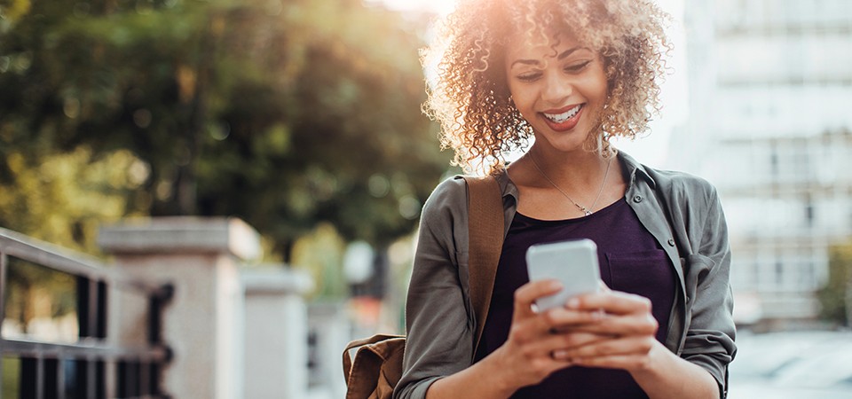 woman paying electric bill on mobile phone
